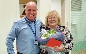 Margaret Hazlett receives flowers from Paul Connelly for 25 years service at CSS