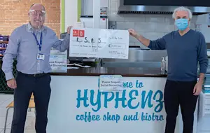 Paul Connelly presenting novelty cheque to elderly & vulnerable at home charity in east end