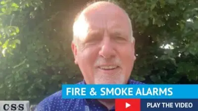 Photo of Paul Connelly talking to the camera with text fire and smoke alarms, play the video.