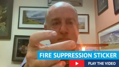 Photo of Paul Connelly with text fire suppression sticker, play the video.
