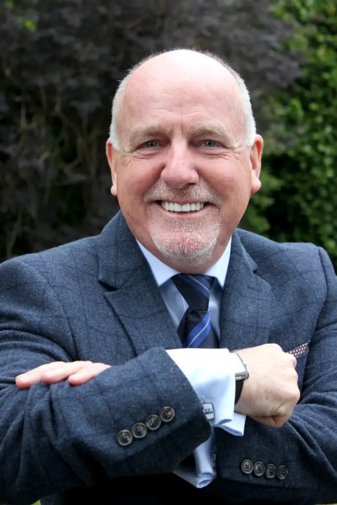 Photo of Paul Connelly smiling and crossing his arms.