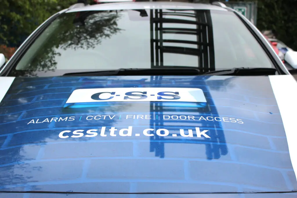 Front view of CSS branded car in blue and white livery.