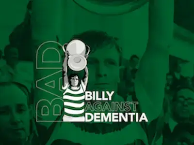 Green box with photo of footballer holding trophy above his head. This image is replicated inside the box on a smaller scale as a drawing of a footballer wearing green and white striped strip and holding a silver above his head. Text reads Billy Against Dementia.