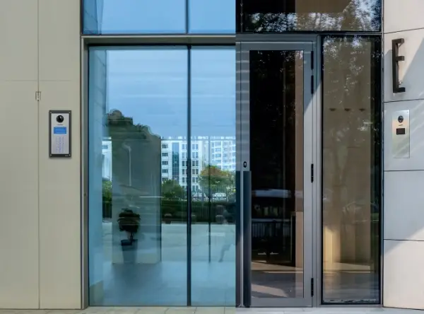 Glass fronted doorway with access panels at each side of the doorway.