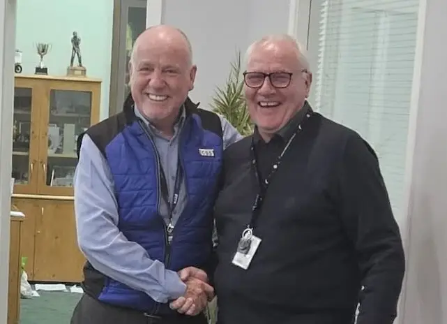 Paul Connelly shaking hands with John McDaid, both smiling - css celebrates john mcdaid work anniversary