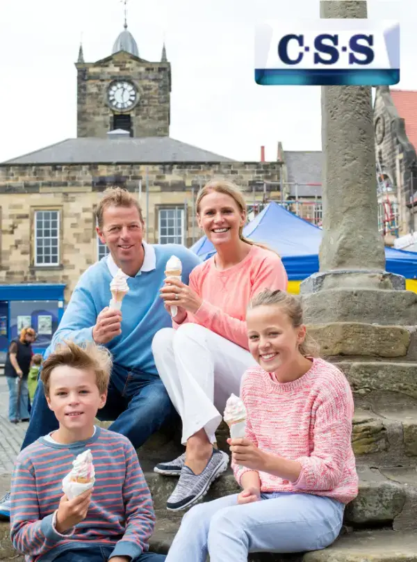 css family days out in scotland - family eating ice cream cones on steps of historic monument